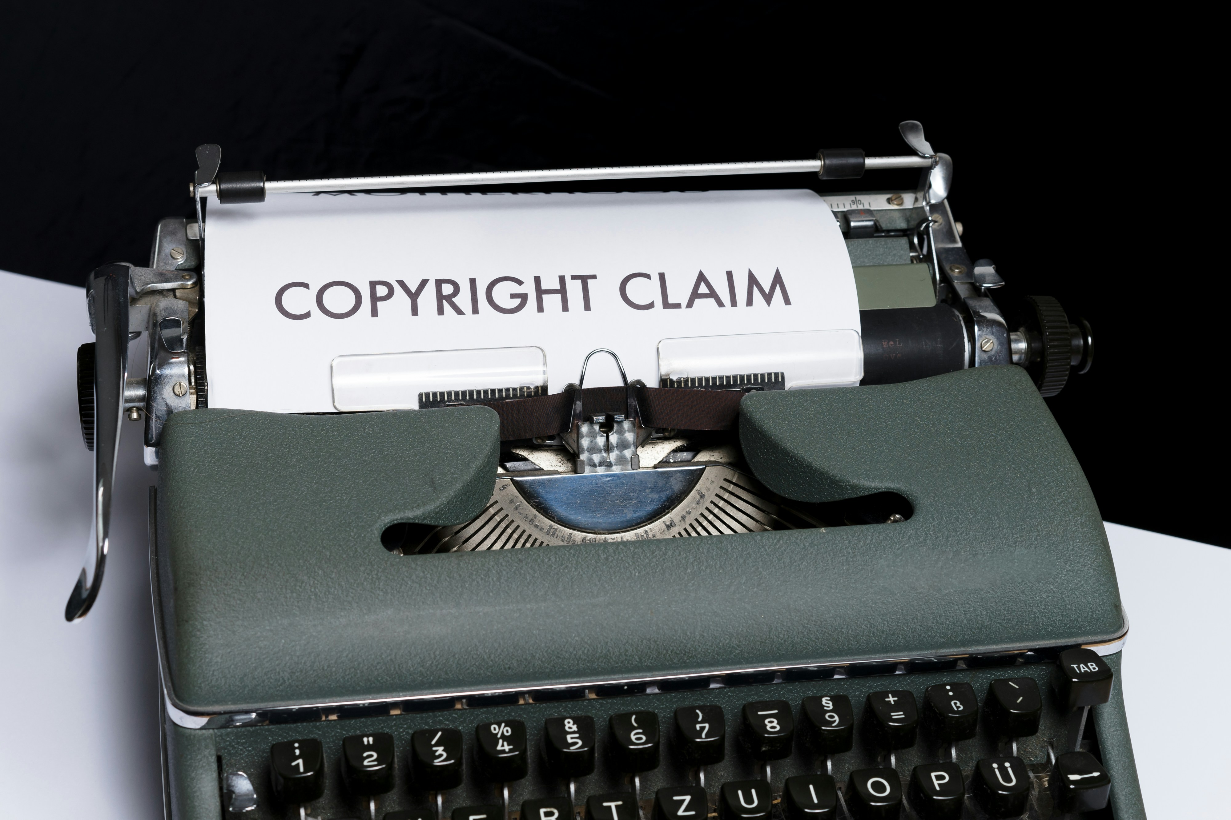 A typewriter with a piece of paper that says Copyright Claim.
