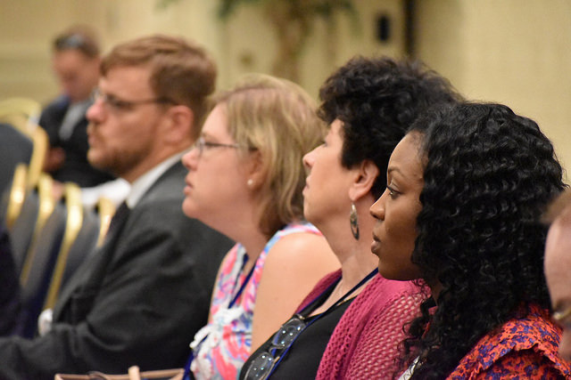 Conference attendees listening to an engaging speaker.