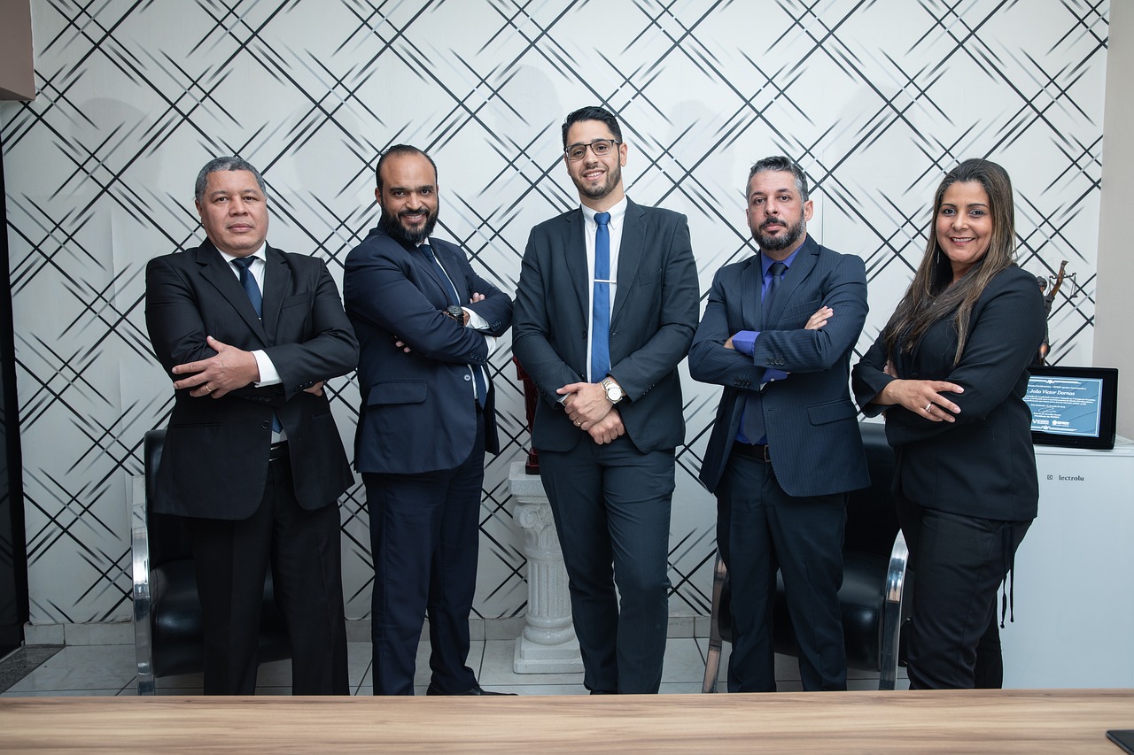 Legal professionals in a law firm, standing near a conference table.